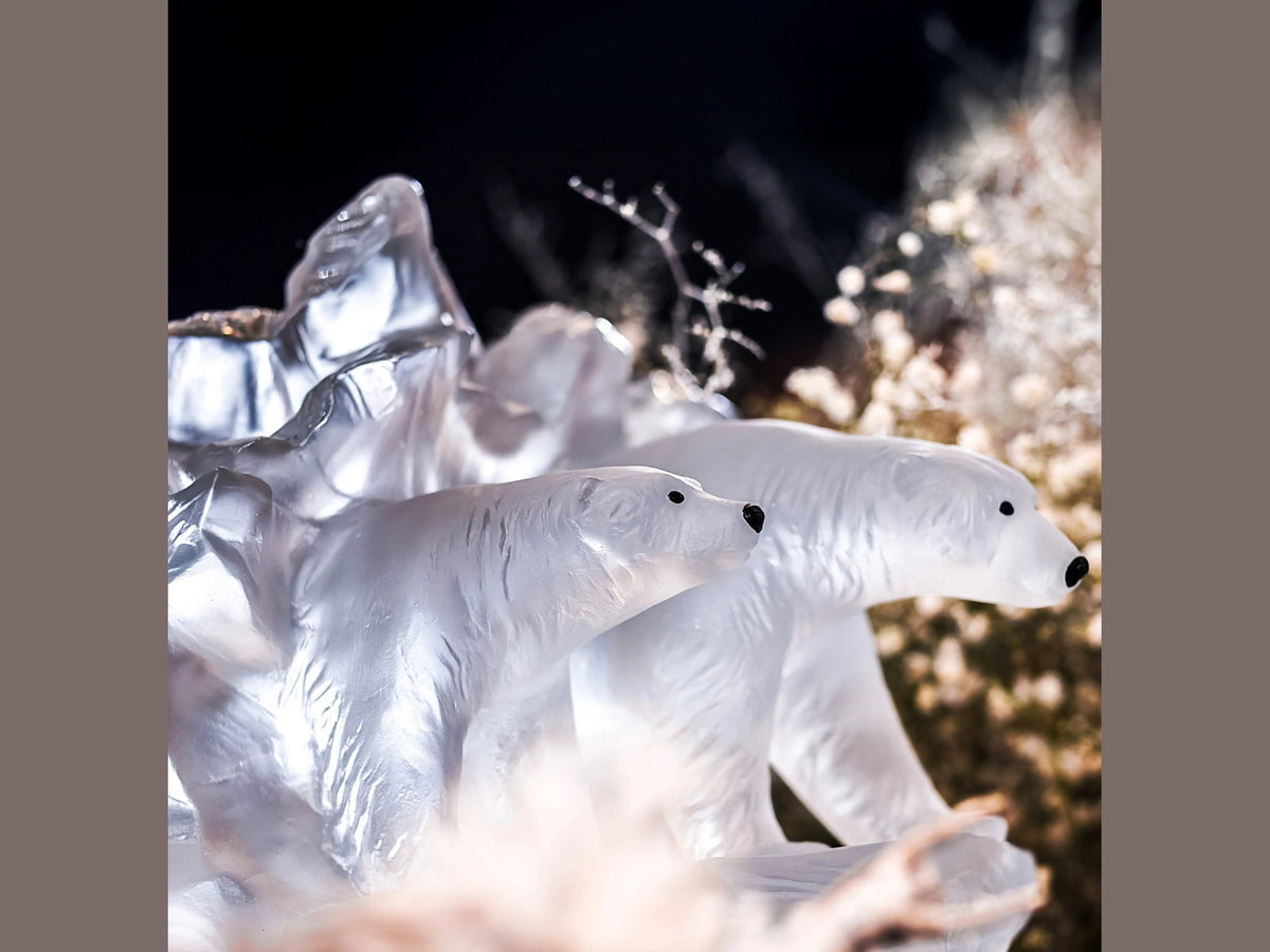 Two frosted glass polar bear sculptures by Daum amidst crystalline ice formations.