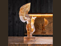 Daum Céyx sculpture by Dominique Vial in translucent amber crystal on a wooden surface