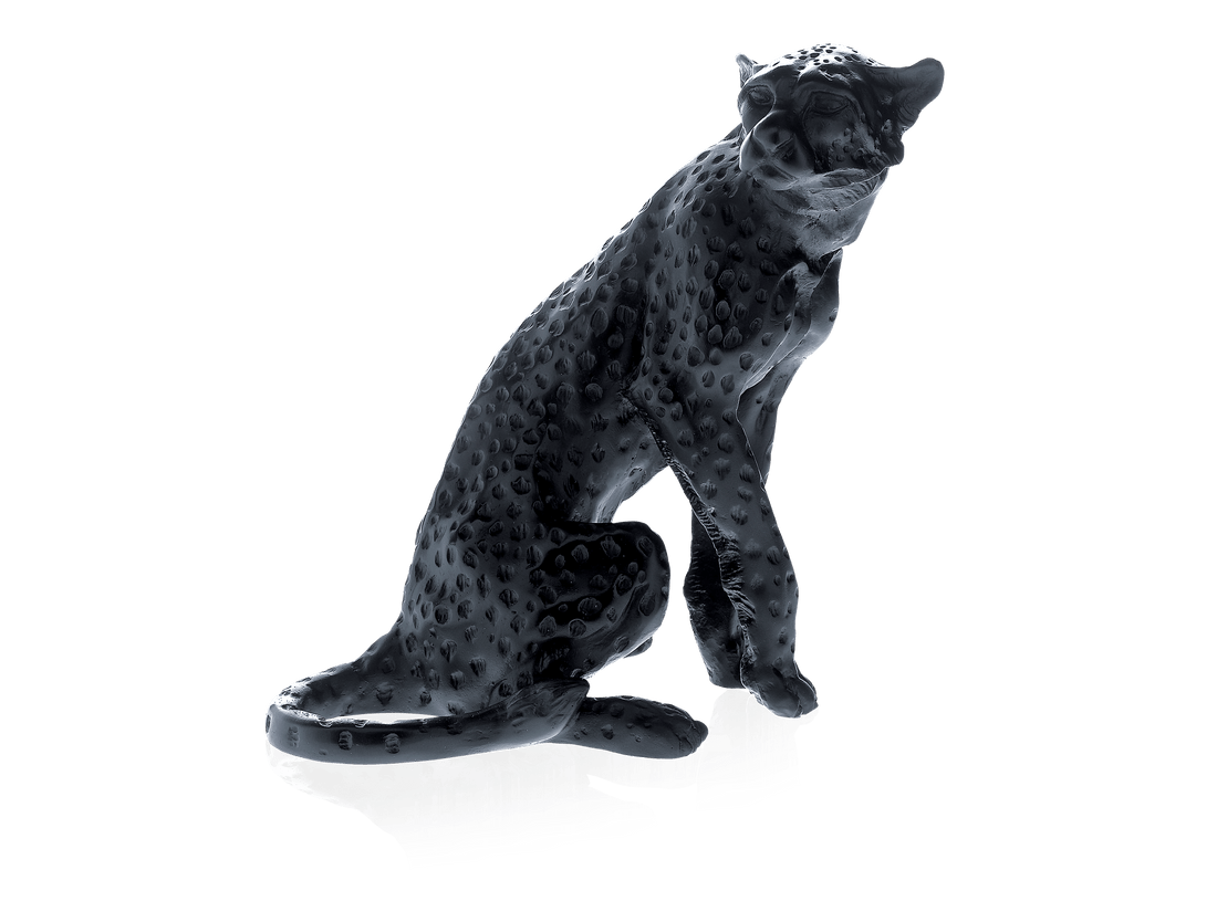 Daum Cheetah Sitting Black sculpture by Jean-François Leroy against a green background