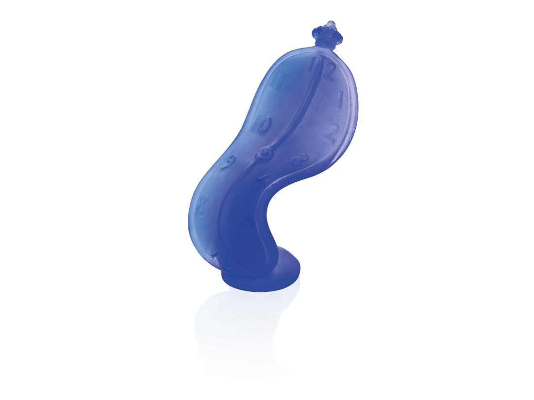 Daum Dance of Time by Salvador Dalí blue glass sculpture on a green background