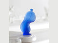 Daum Dance of Time by Salvador Dali blue glass sculpture on a white surface
