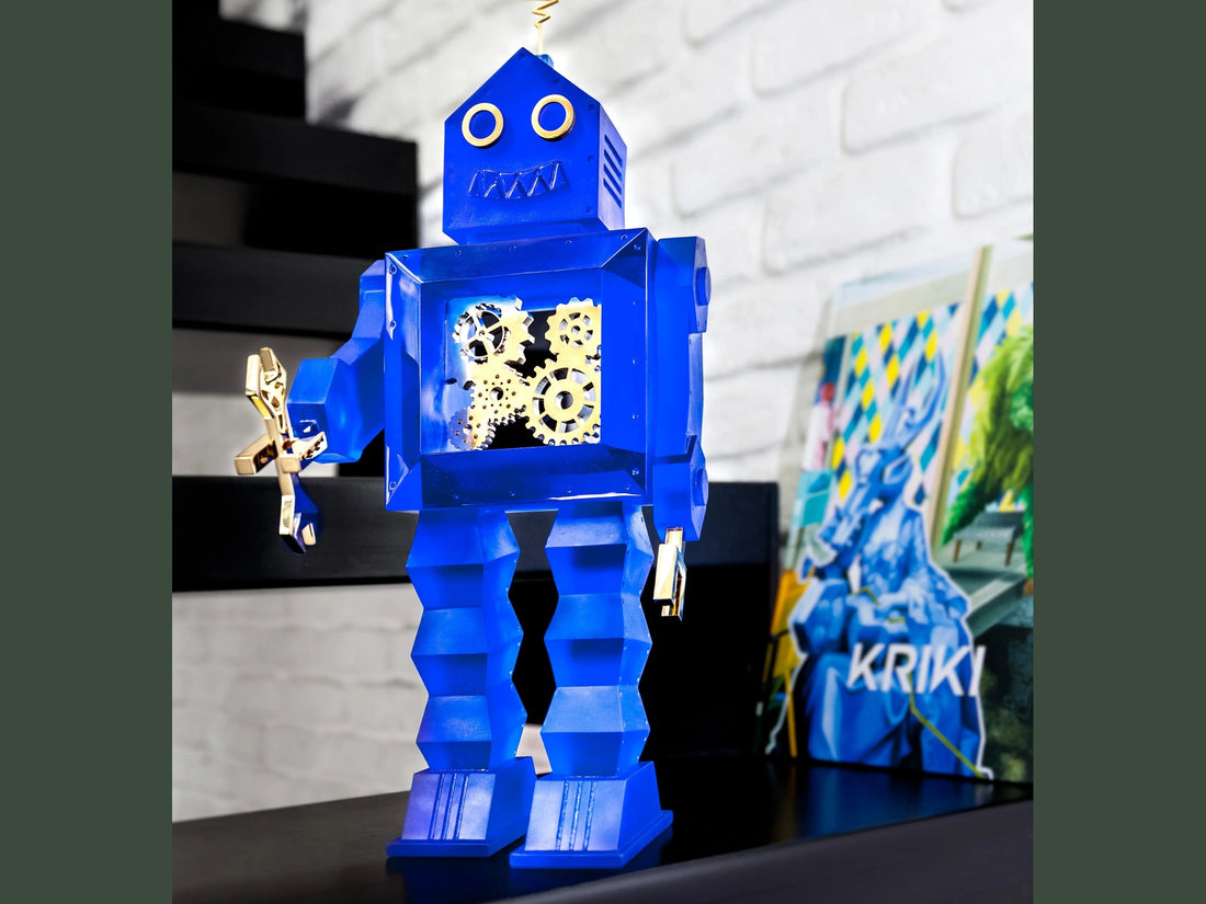 Blue Daum robot wind-up toy with visible gold gears and a golden key.