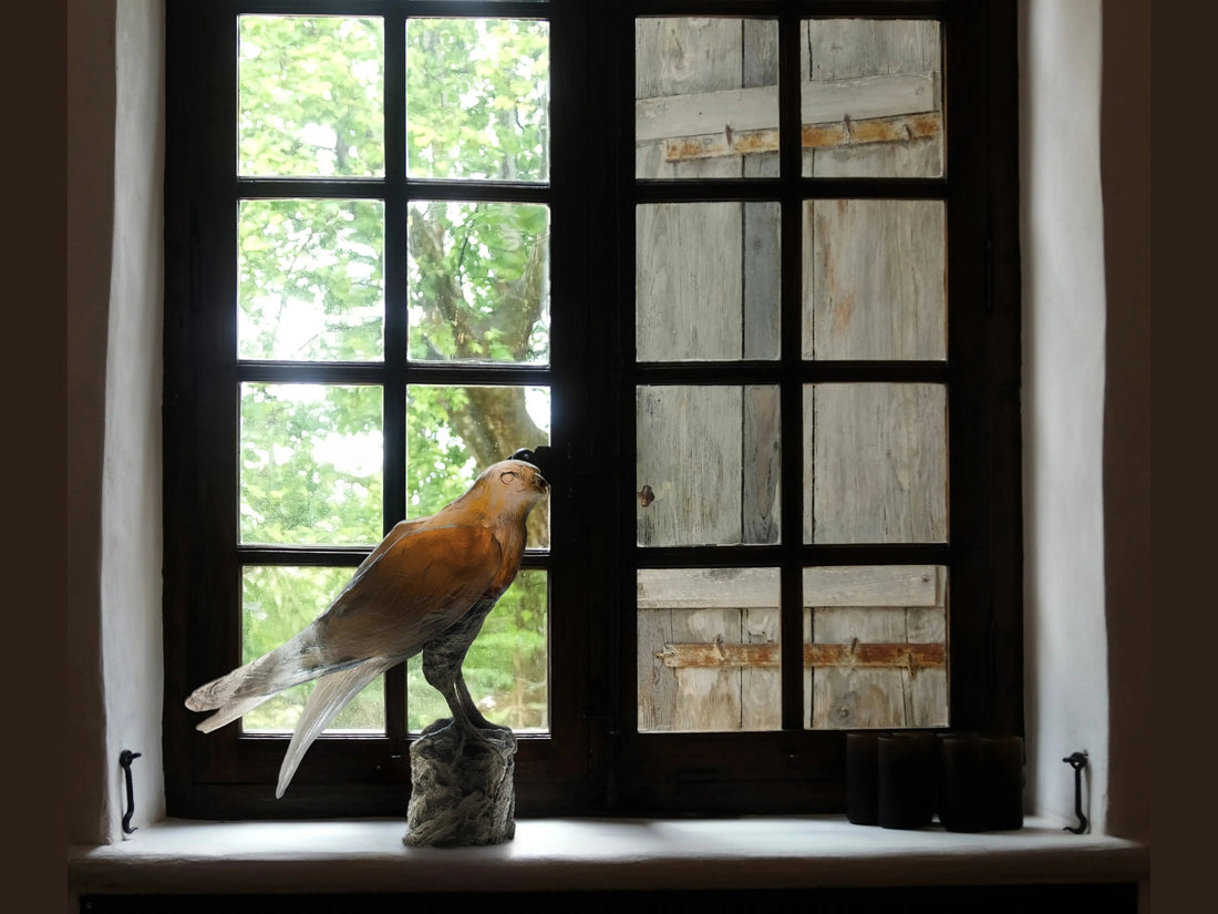 Daum Saker Falcon sculpture by Madeleine Van der Knoop on a textured base