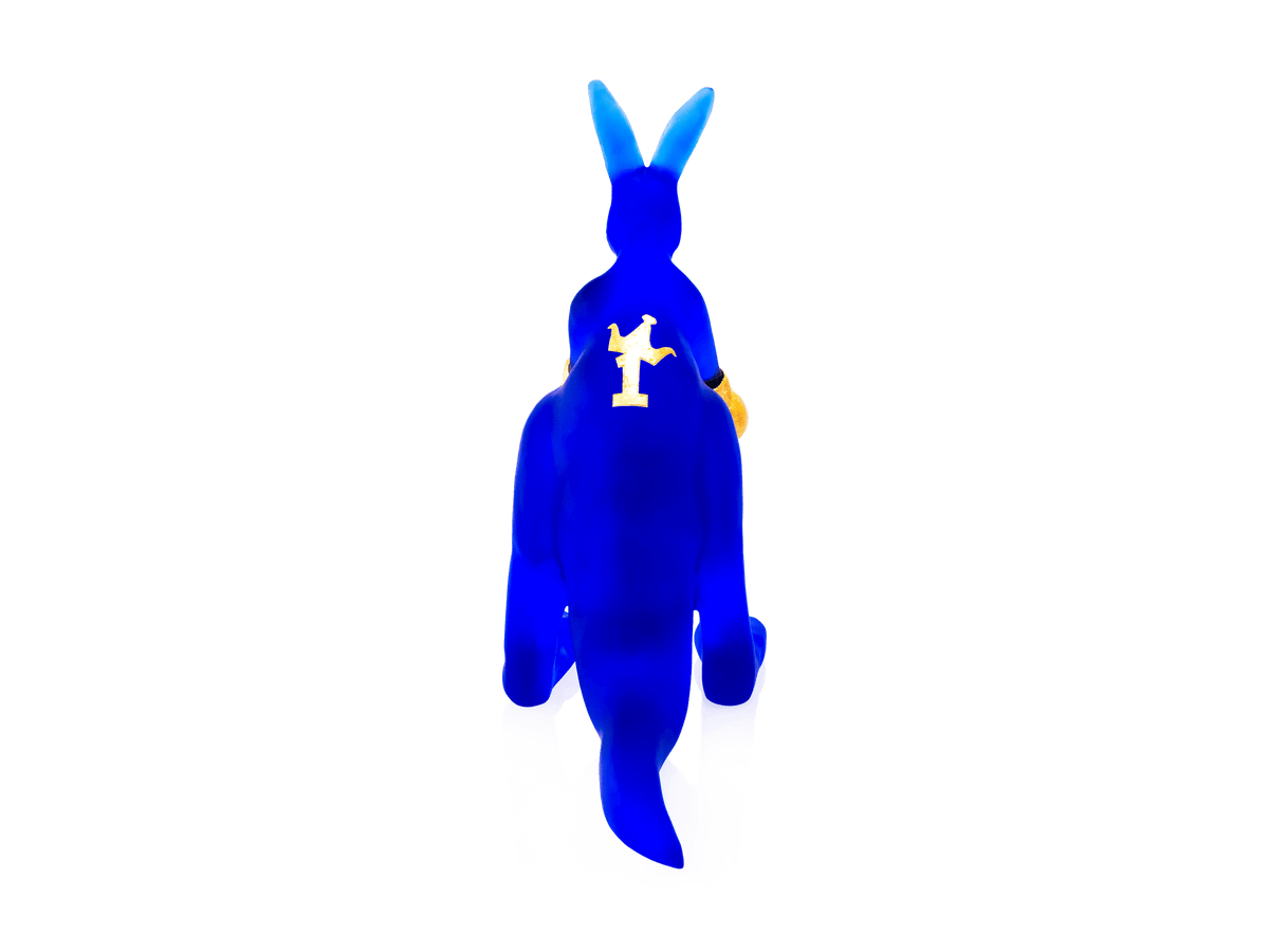 Blue Daum Kangourou Wally glass figurine by Yves Henry on a white background.