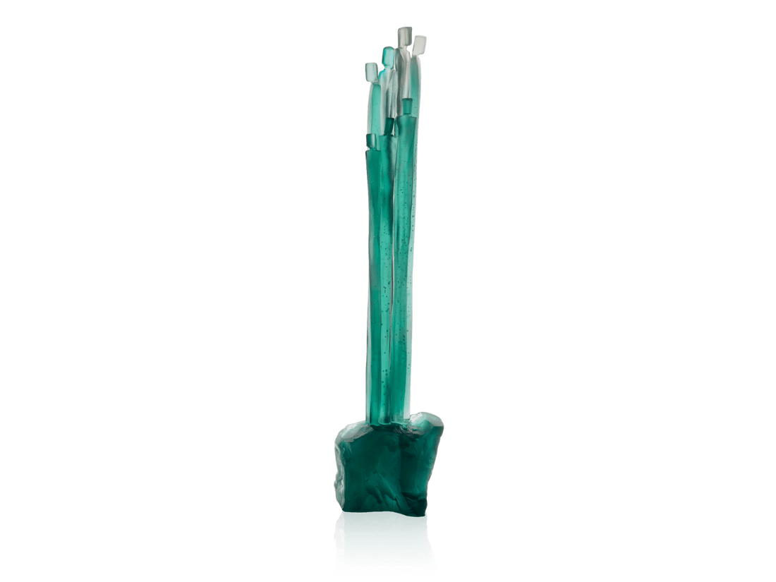 Daum Laurence Bonnel set featuring teal glass sculpted elements on a green background.