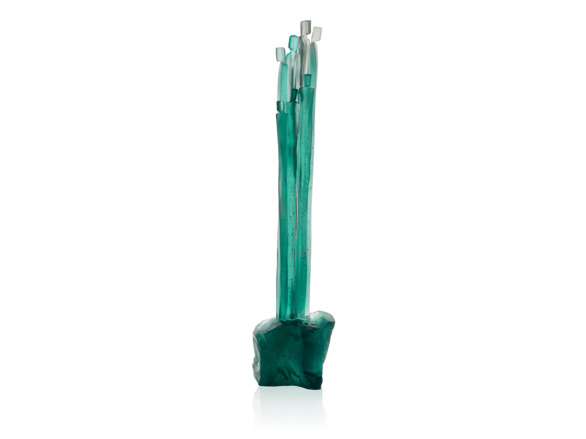 Daum Laurence Bonnel set featuring teal glass sculpted elements on a green background.