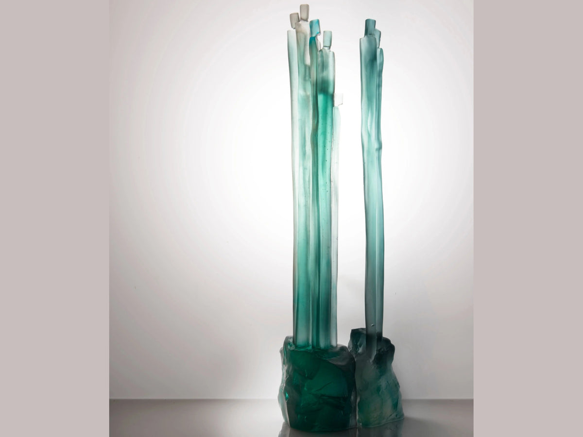 Daum Laurence Bonnel glass sculpture featuring tall, teal crystalline pillars