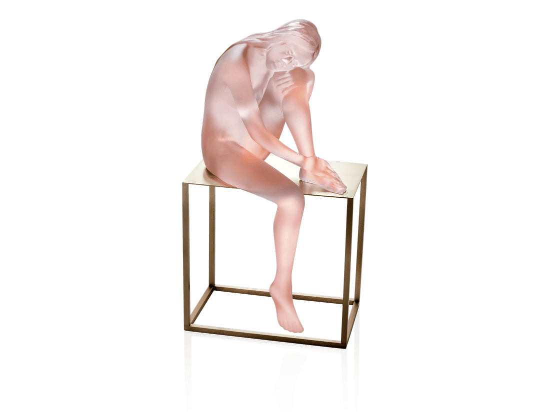 Daum Louison sculpture of a frosted pink glass figure sitting on a gold metal stand