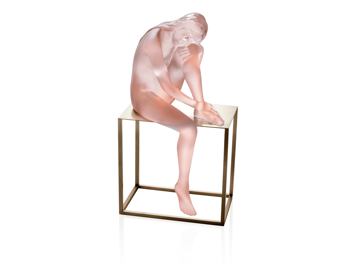Daum Louison sculpture of a frosted pink glass figure sitting on a gold metal stand