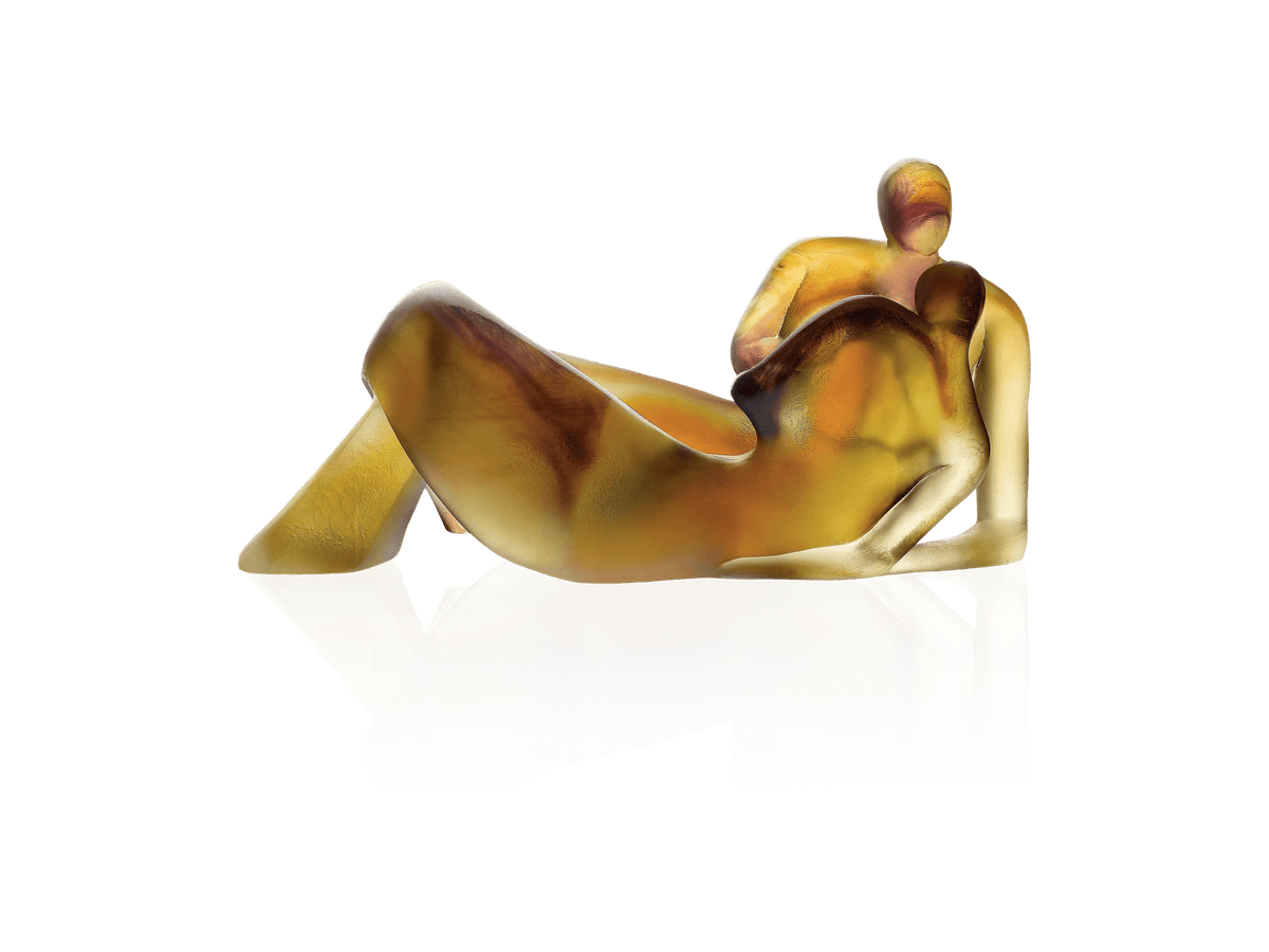 Daum Lune de miel glass sculpture of two embracing figures in amber and gold tones.