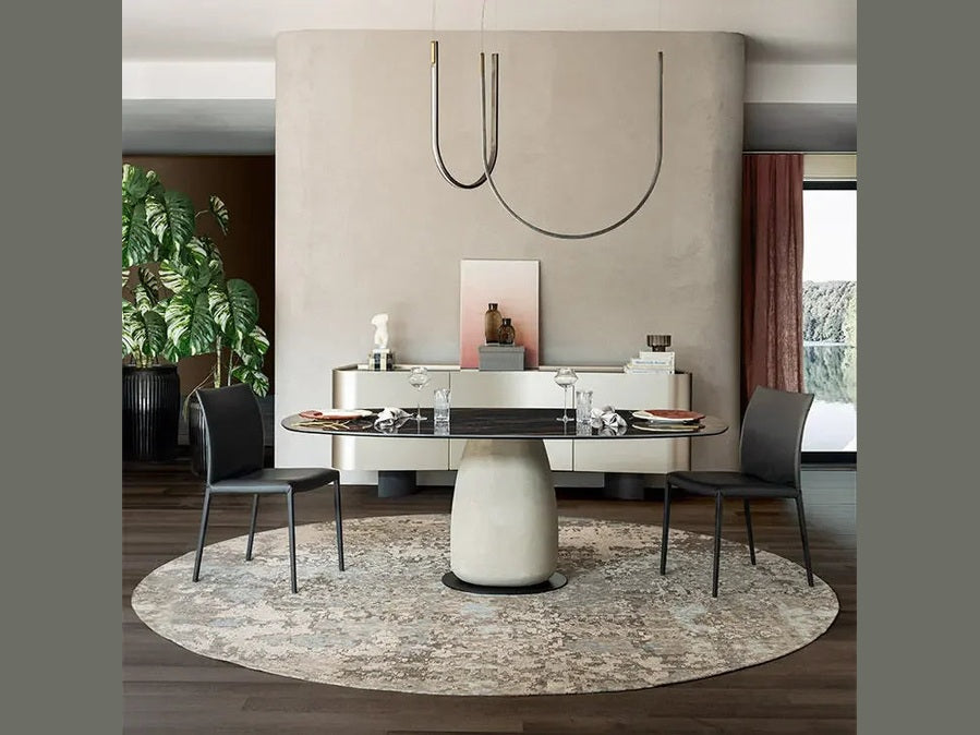 Cattelan Italia BOTERO Keramik dining table with black chairs and modern pendant light.