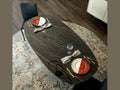 Cattelan Italia BOTERO Keramik oval dining table with dark marble finish and elegant place settings.