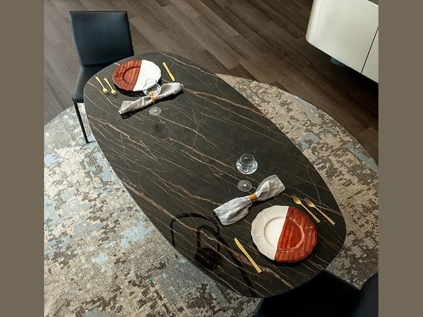 Cattelan Italia BOTERO Keramik oval dining table with dark marble finish and elegant place settings.