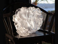 Daum Camelia Coupe petit modèle Blanche glass flower sculpture on a dark chair