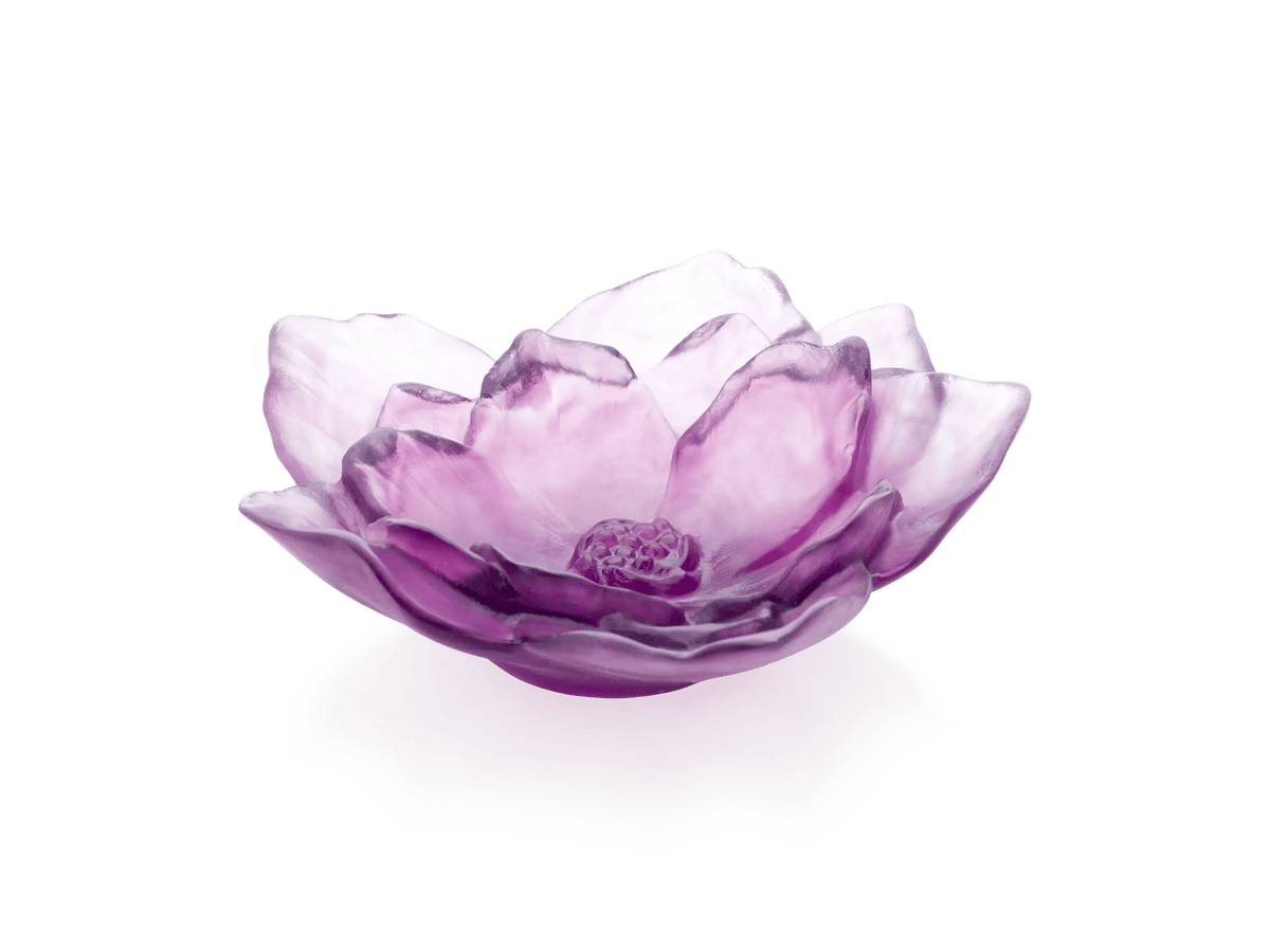 Daum Camelia Coupe in violet glass, shaped like a blooming flower on a white base.