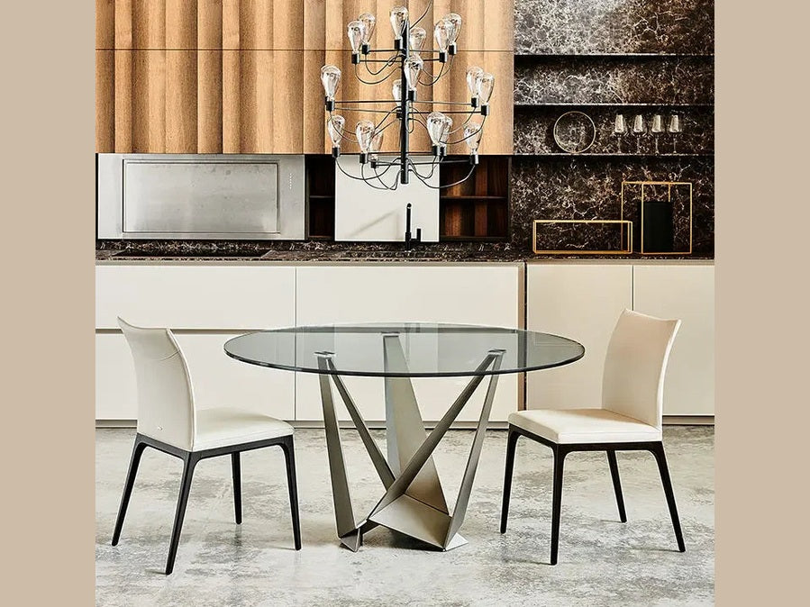 Cattelan Italia SKORPIO Round glass dining table with modern sculptural base and white chairs.