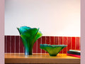 Daum Ginkgo Coupe Haute Verte green glass decorative bowls on a wooden surface.