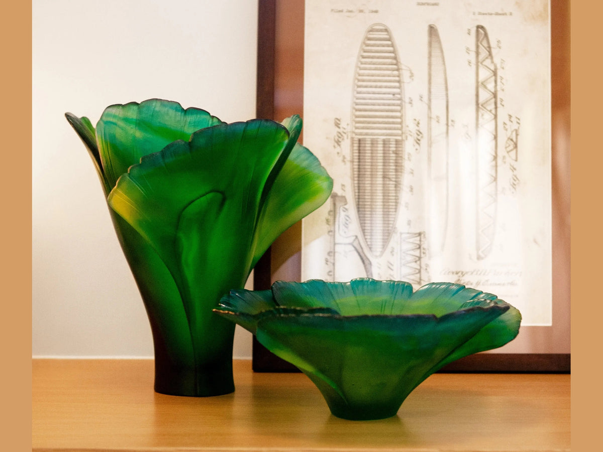 Daum Ginkgo Coupe Haute Verte green glass vases on a wooden surface