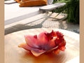 Daum Safran Coupe crystal glass bowl with red and orange floral petal design on a table.