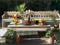 Daum Tutti Frutti Coupe filled with colorful fruit on a wooden outdoor table.