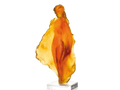 Amber-colored Daum glass sculpture 'Marine' by Michel Coste on a white base against a green background
