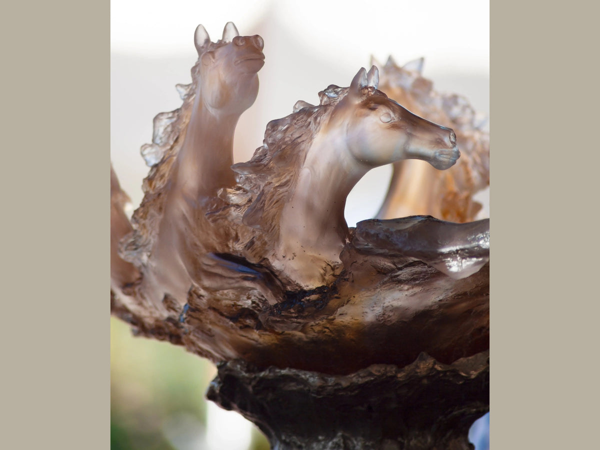 Close-up of Daum Cavalcade centerpiece featuring iced brown glass horse sculptures.