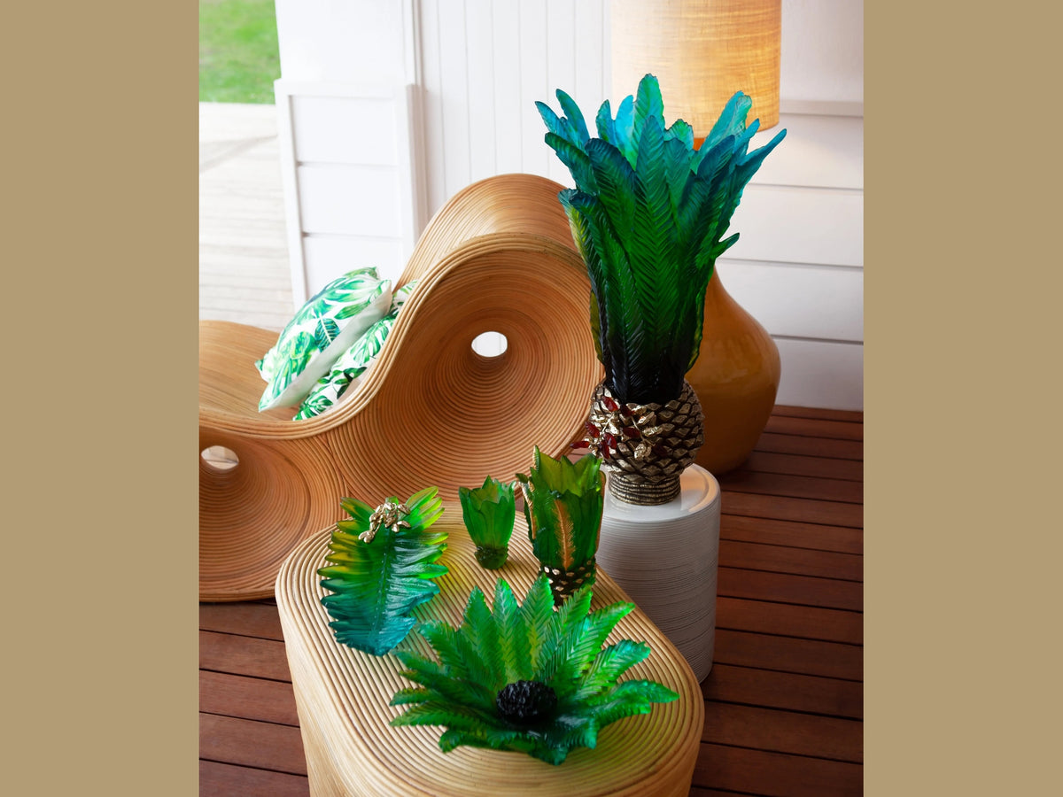 Daum Palm Beach green glass centerpieces on a rattan table and chair
