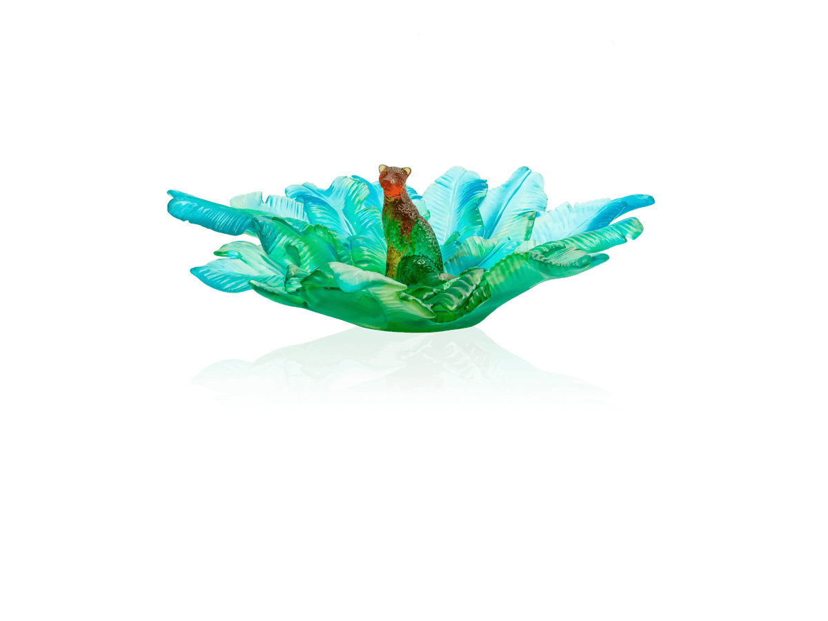 Daum Voyage Tropical center piece featuring a green panther among blue glass leaves.