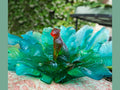 Daum Voyage Tropical glass centerpiece featuring a colorful tropical bird figurine.