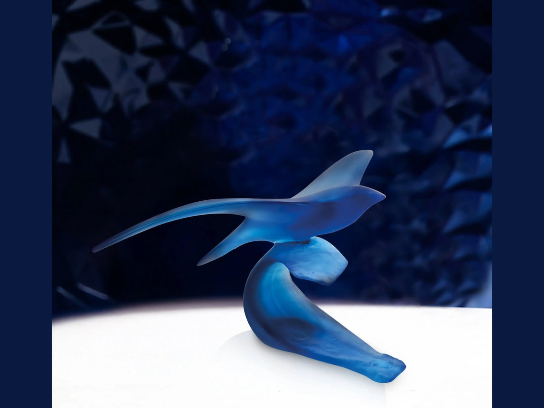 Blue Daum Oiseau Marin glass sculpture by Xavier Carnoy on a black background.