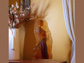 Daum Pénélope glass sculpture by Marie-Paule Deville-Chabrolle on a wooden surface.