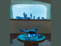 Blue Daum glass manta ray sculpture by Umberto Nuzzo displayed on a table.