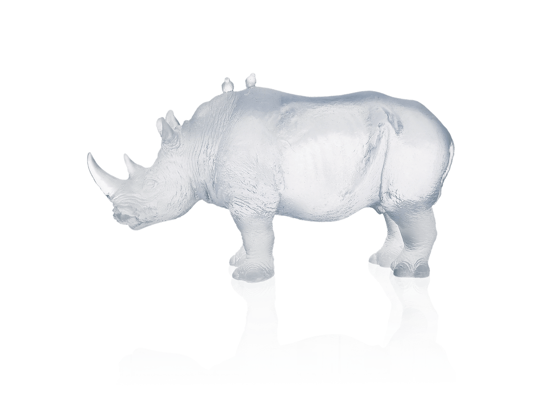 Daum Rhinocéros Blanc crystal sculpture by Jean-François Leroy on a green background