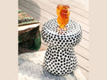 Daum Secret d'amour glass sculpture on a black and white polka dot side table