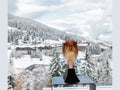 Daum Tête de Faucon glass sculpture by Madeleine Van der Knoop set against a snowy mountain view.