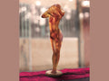 Daum Woman in a Sweater crystal sculpture by Nadine Enakieff on a red velvet surface.