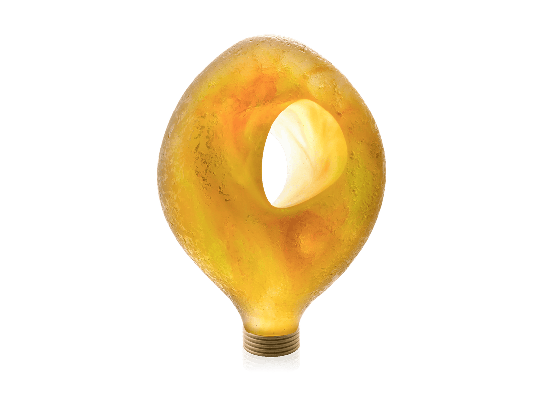 Daum Yeelen solaire sculpture in yellow glass shaped like a light bulb against a green background